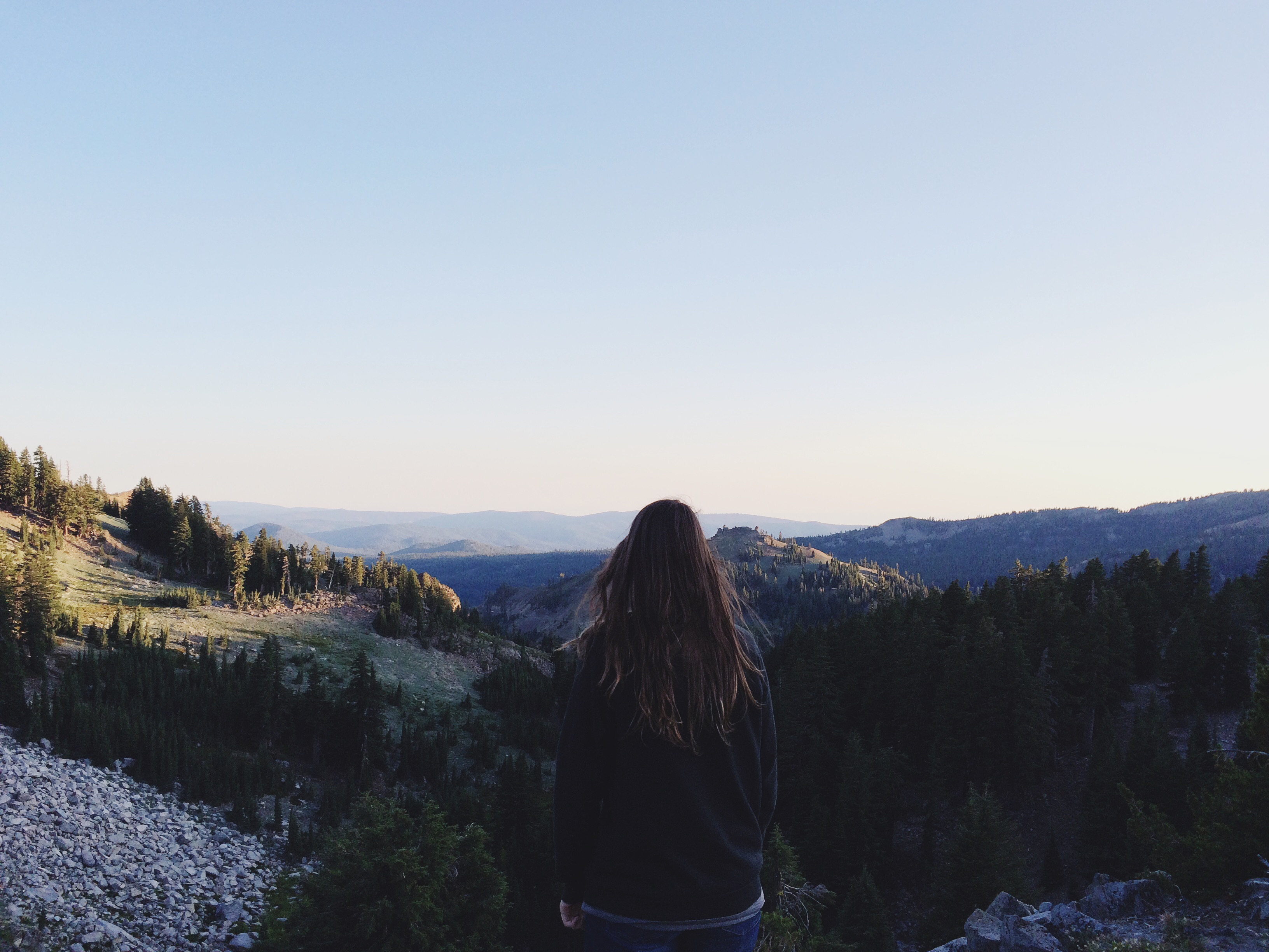 girl standing on cliff- overlooking mountain